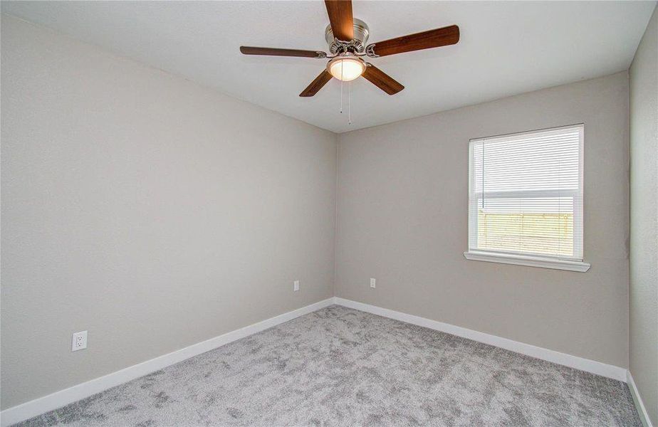 Bedroom 2 view to hallway. Updated carpet, light fixtures and private closet and view to large backyard.