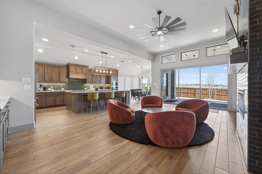 Living area anchored by floor-to-ceiling tiled fireplace and custom wine cabinet Living area anchored by floor-to-ceiling tiled fireplace and custom wine cabinet