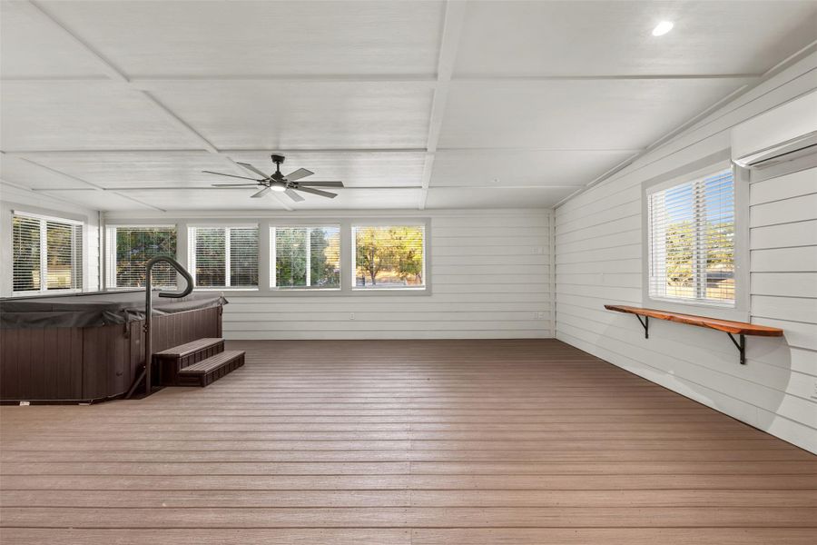 Unfurnished sunroom featuring a jacuzzi