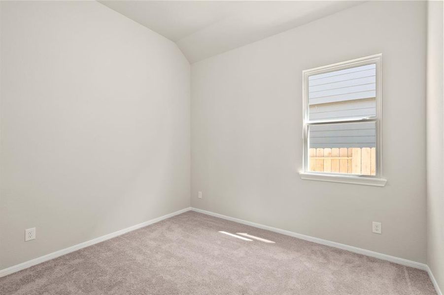 Your secondary bedroom features plush carpet, fresh paint, closet, and a large window that lets in plenty of natural lighting.