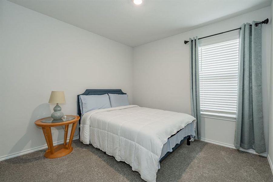 Bedroom with baseboards and carpet floors