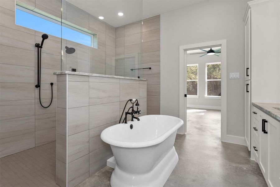A beautiful standalone soaking tub serves as a relaxing centerpiece, perfect for unwinding at the end of the day. The expansive dual-entry shower adds a spa-like touch while enhancing ease of access and flow within the space. Completing the retreat is a private water closet, offering added privacy and comfort.