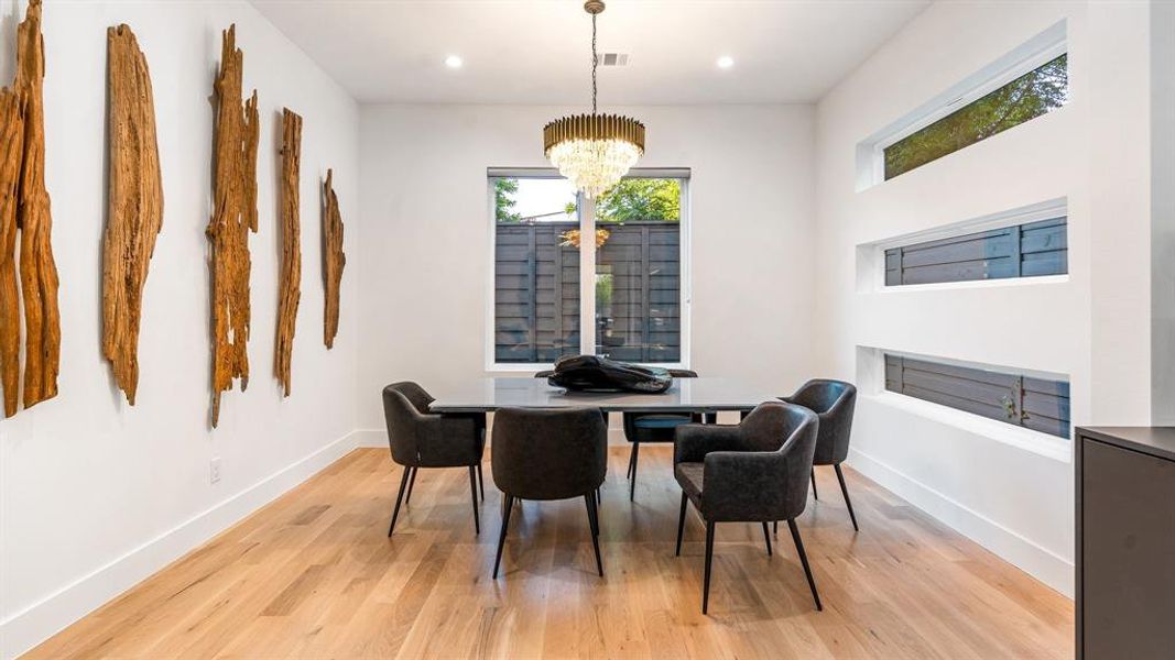 Dining space featuring a notable chandelier and light hardwood / wood-style flooring