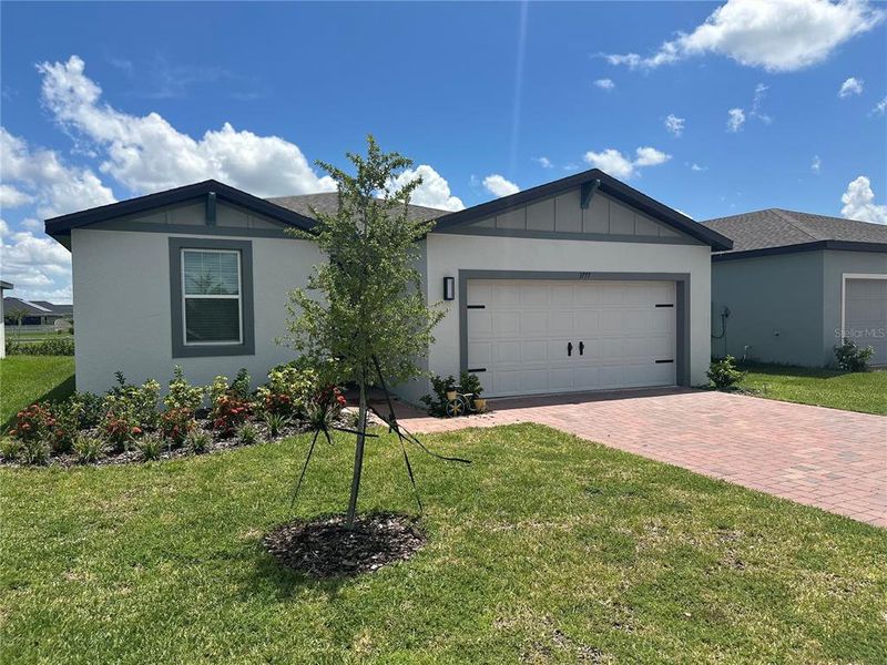 Front exterior of a new home in Villamar - Signature Series, Winter Haven, FL, highlighting curb appeal (Image 19).