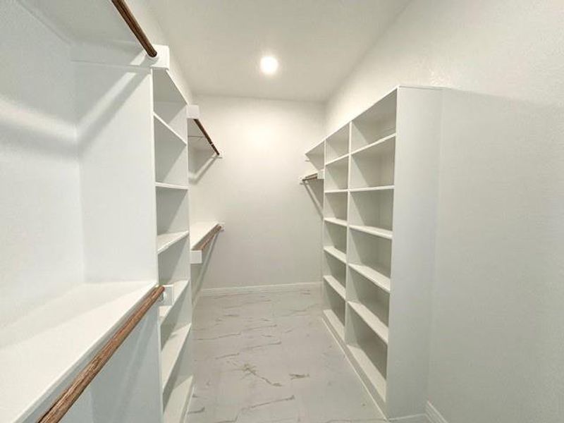 View of spacious primary bedroom closet