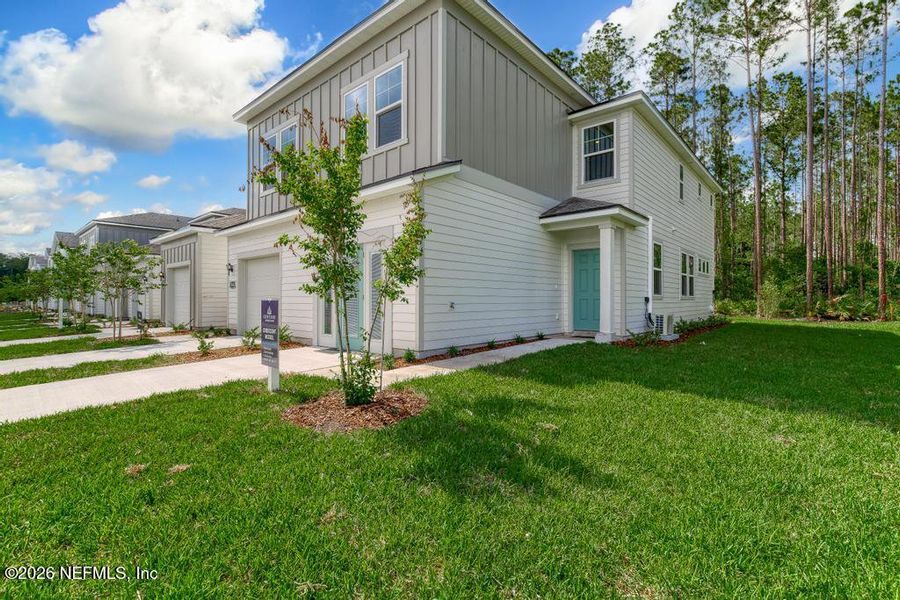 Front exterior of a new home in The Villas at Bishop Oaks, Jacksonville, FL, highlighting curb appeal (Image 26).