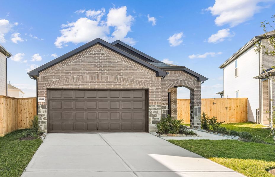 Front exterior of a new home in Mavera, Conroe, TX, highlighting curb appeal (Image 2).