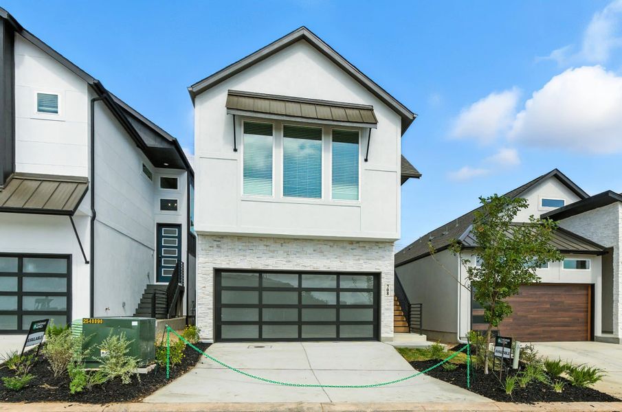 Front exterior of a new home in Centero at Stone Oak, San Antonio, TX, highlighting curb appeal (Image 19). Front exterior of a new home in Centero at Stone Oak, San Antonio, TX, highlighting curb appeal (Image 19).