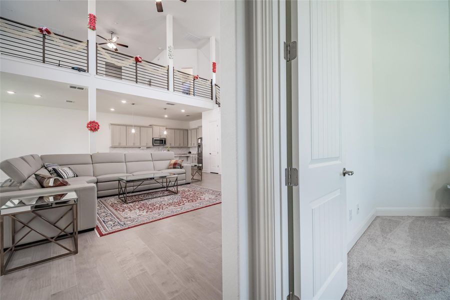 A spacious great room with a second-story loft connects to an open-concept kitchen.