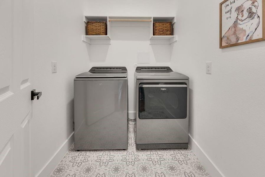 Laundry area featuring washer and clothes dryer and baseboards