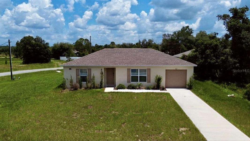 Front exterior of a new home in Poinciana, Poinciana, FL, highlighting curb appeal (Image 23). Front exterior of a new home in Poinciana, Poinciana, FL, highlighting curb appeal (Image 23).