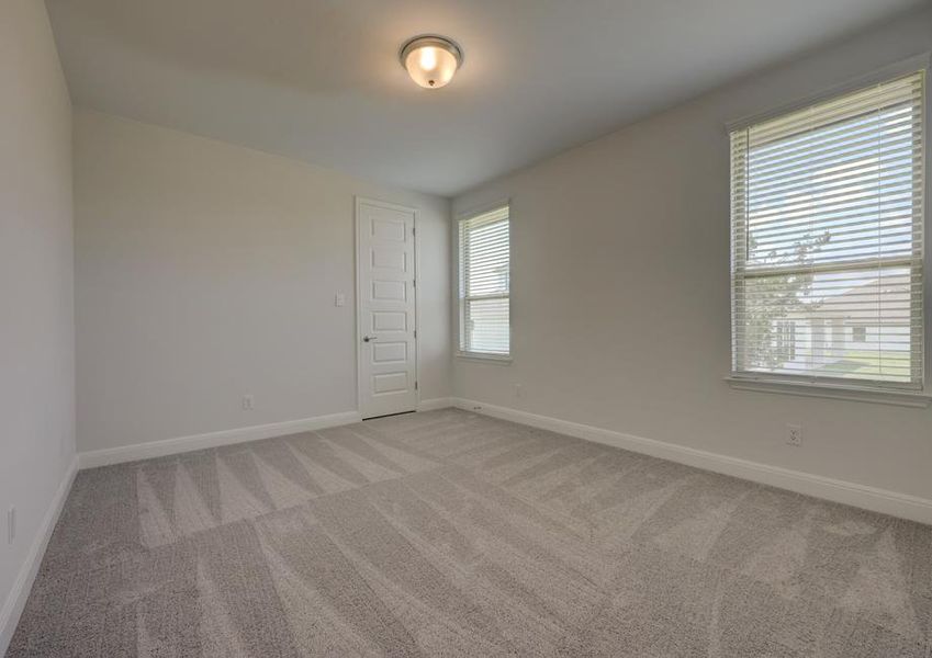 Secondary bedroom with two windows to allow natural light to flow through.