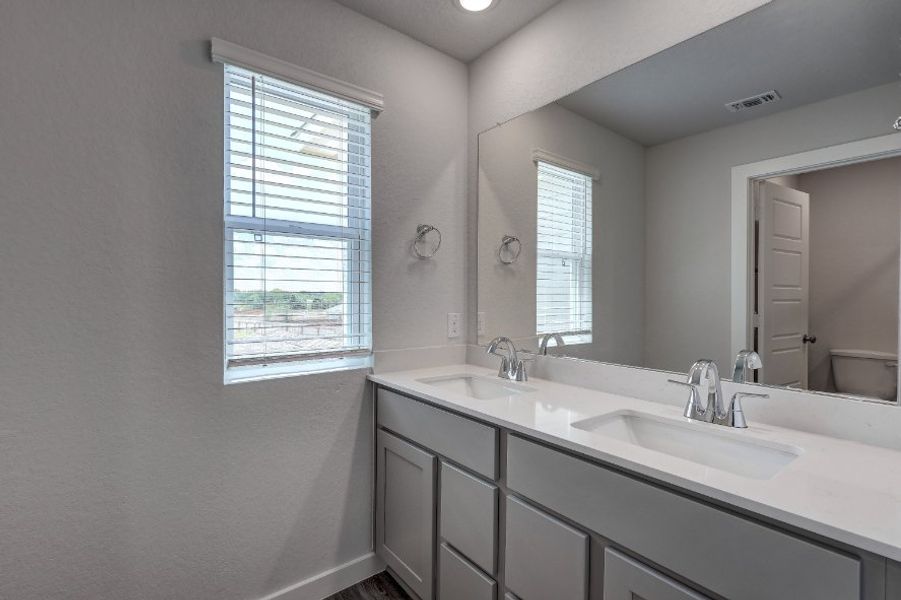 A bathroom with a large mirror.
