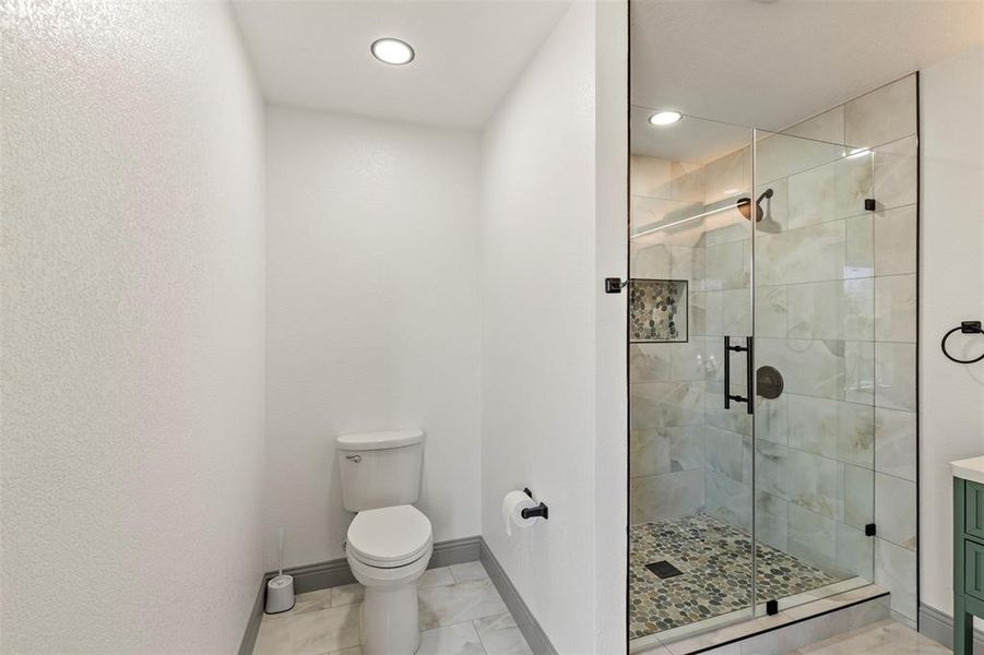 Bathroom featuring a shower stall, vanity, and recessed lighting