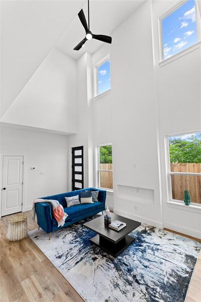 Vaulted ceilings featuring a contemporary ceiling fan and multiple windows for abundant natural light