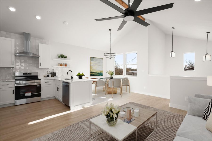 Living room featuring light wood-style floors, hanging lights, vaulted ceiling, and a ceiling fan