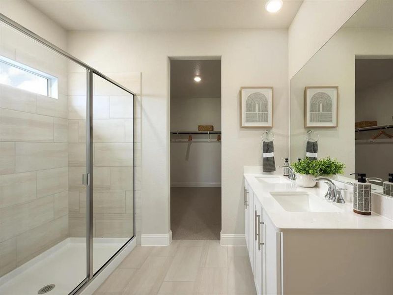 Bathroom with a spacious closet, double vanity, a stall shower, and recessed lighting