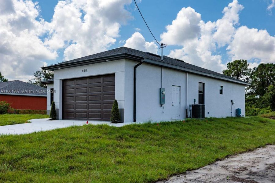 Front exterior of a new home in , Lehigh Acres, FL, highlighting curb appeal (Image 1). Front exterior of a new home in , Lehigh Acres, FL, highlighting curb appeal (Image 1).