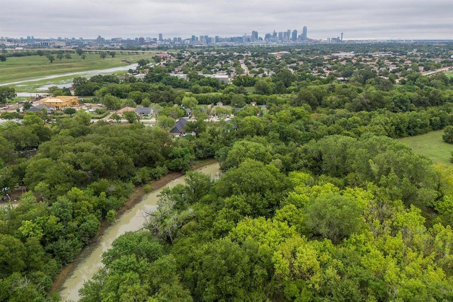 Expansive natural setting featuring dense tree cover and a winding waterway Expansive natural setting featuring dense tree cover and a winding waterway