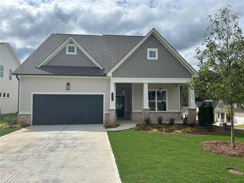 Front exterior of a new home in Cooks Farm, Woodstock, GA, highlighting curb appeal (Image 1).