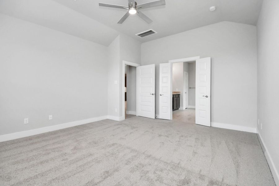 Escape and relax in the exquisite primary suite, a haven to unwind after a long day. The spacious room, situated on the first floor, boasts plush carpeting, soothing paint tones, high ceilings, and expansive windows adorned with privacy blinds. Sample photo of completed home with similar floor plan. Actual colors and selections may vary. Escape and relax in the exquisite primary suite, a haven to unwind after a long day. The spacious room, situated on the first floor, boasts plush carpeting, soothing paint tones, high ceilings, and expansive windows adorned with privacy blinds. Sample photo of completed home with similar floor plan. Actual colors and selections may vary.