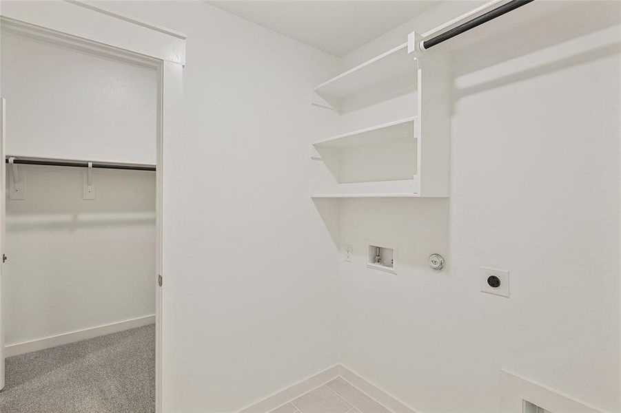 Laundry room with hookup for a gas dryer, hookup for an electric dryer, light carpet, and hookup for a washing machine