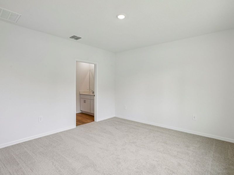 The Primary Bedroom of the Acadia at 7521 Mia Vine Dr.