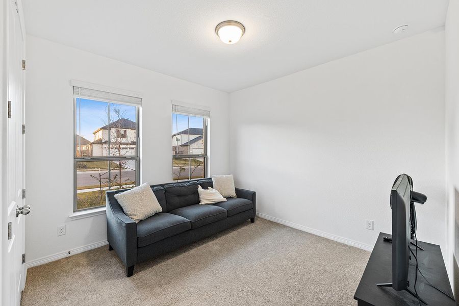 Sitting room featuring carpet floors