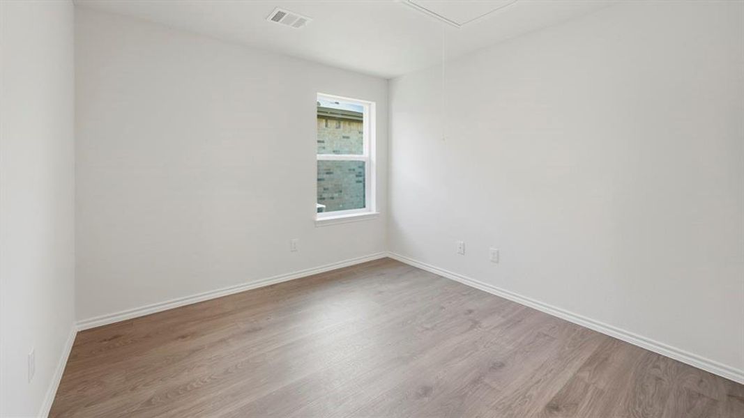 Unfurnished room featuring attic access and wood finished floors Unfurnished room featuring attic access and wood finished floors