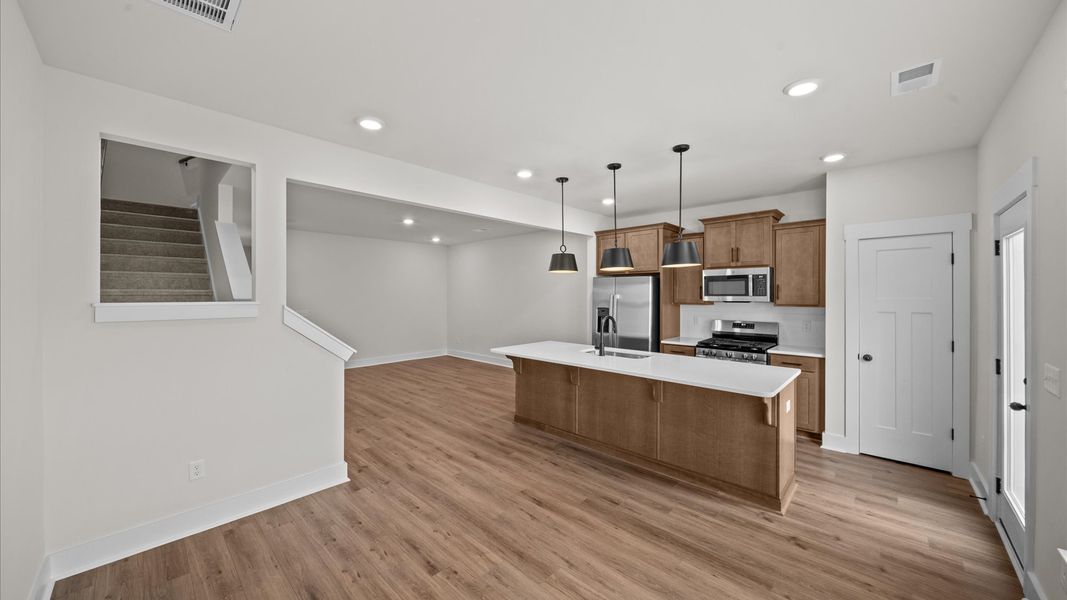 Exclusive kitchen design with large island, pendant lights, and tasteful finishes throughout Exclusive kitchen design with large island, pendant lights, and tasteful finishes throughout