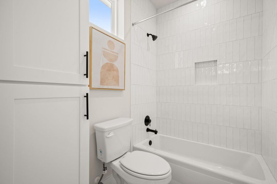 Full bathroom featuring tub / shower combination and toilet