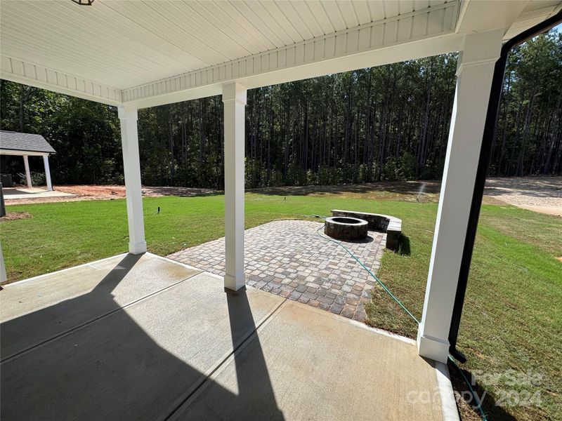 Covered rear porch with paver patio and Firepit