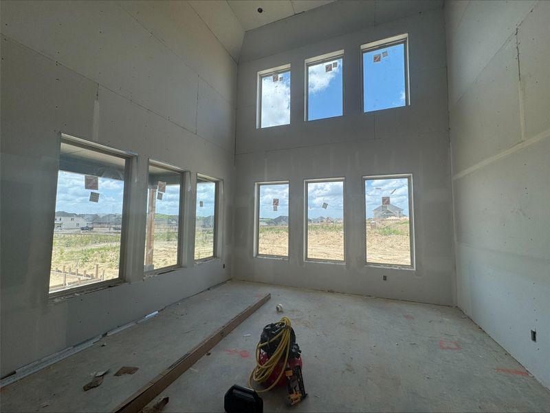 Unfurnished room featuring a high ceiling