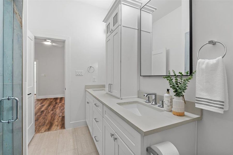 Bathroom with wood-type flooring, vanity, and a shower with door