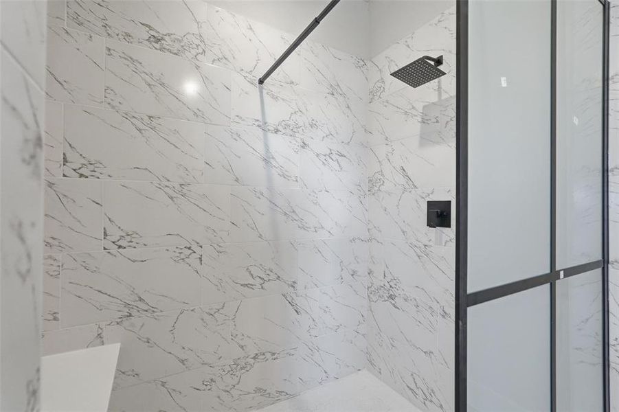 Bathroom featuring a marble finish shower
