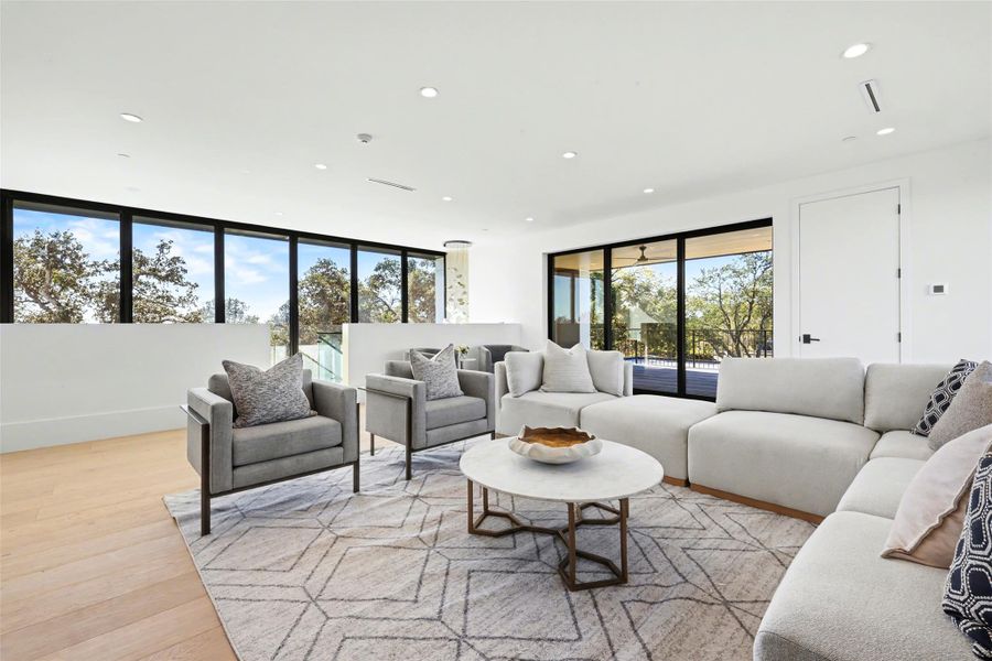 Living room featuring light wood finished floors and recessed lighting