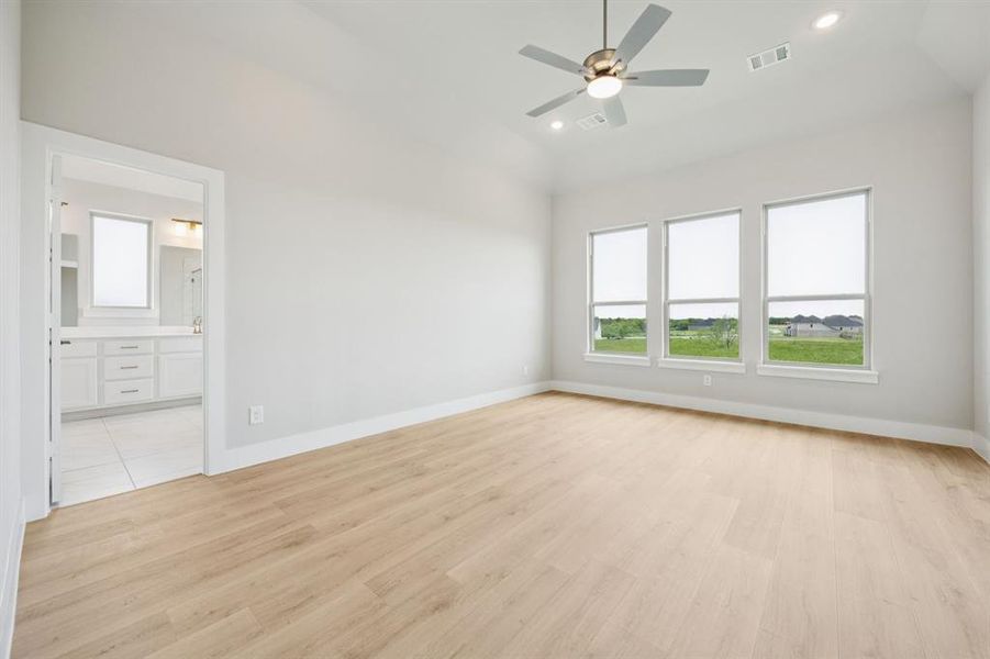 Unfurnished bedroom with light wood-style floors, ceiling fan, recessed lighting, and connected bathroom