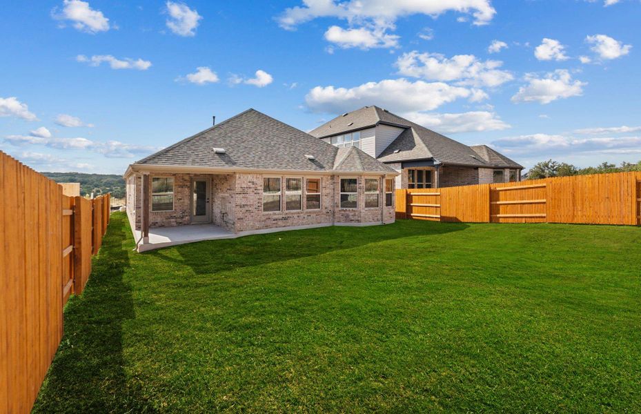 Exterior details and patio area of a home in West Cypress Hills, Spicewood (Image 3).