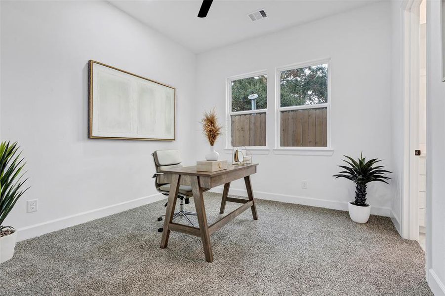 The first floor bedroom can be used as a guest room, or perhaps a home office! This is a photo of another unit as a representation of finishes. (Model Unit 9424C)