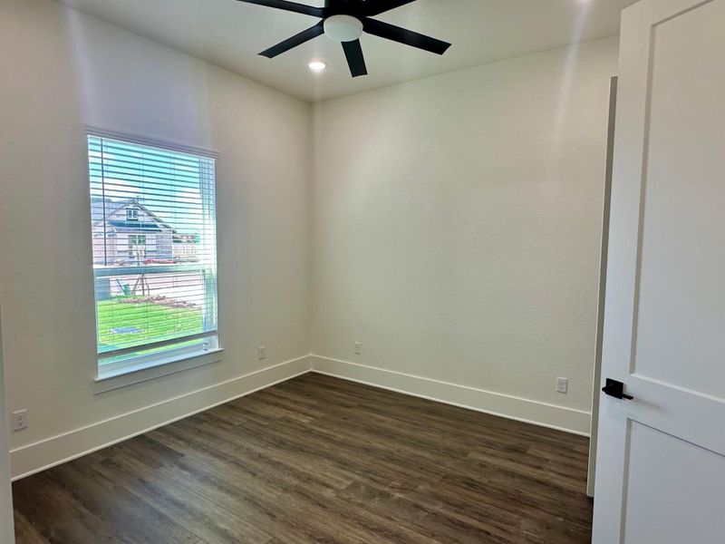Spare room featuring dark wood finished floors, ceiling fan, and recessed lighting