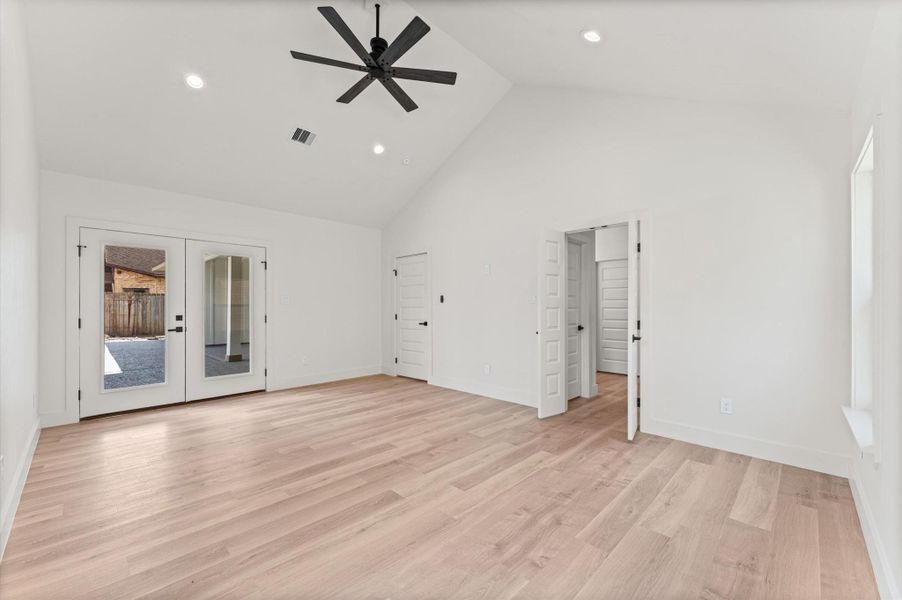 The primary bedroom has cathedral ceilings, access to the back patio & pool, and ample space for a separate seating area.