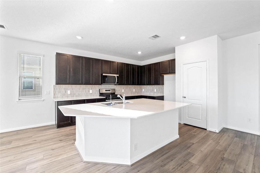 With a highly functional layout, this spacious kitchen offers generous counter space and ample storage, making it the true heart of the home. With a highly functional layout, this spacious kitchen offers generous counter space and ample storage, making it the true heart of the home.