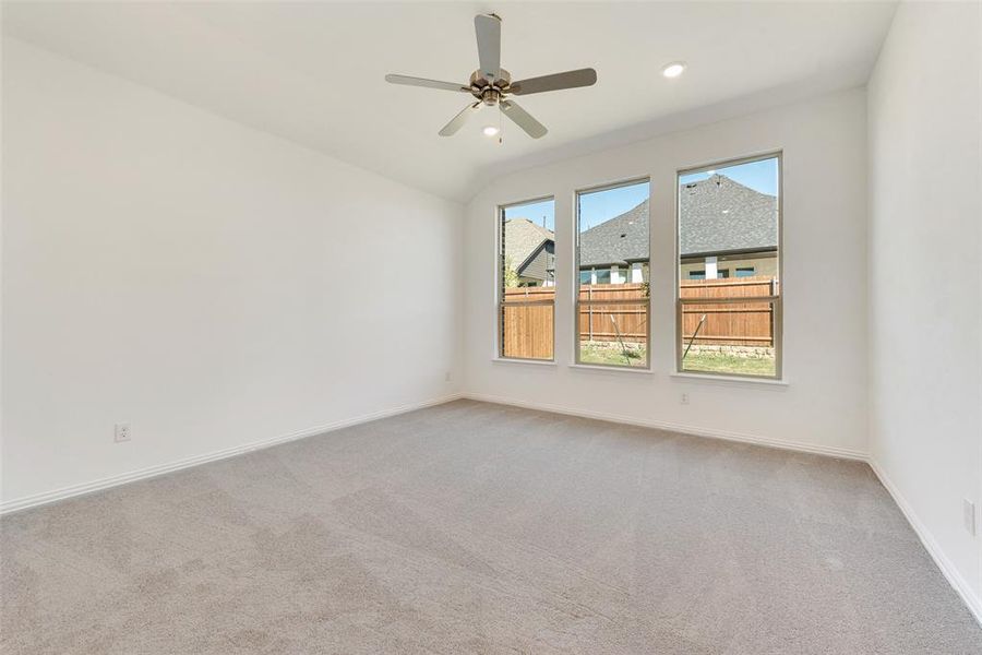 Unfurnished room featuring ceiling fan and light colored carpet