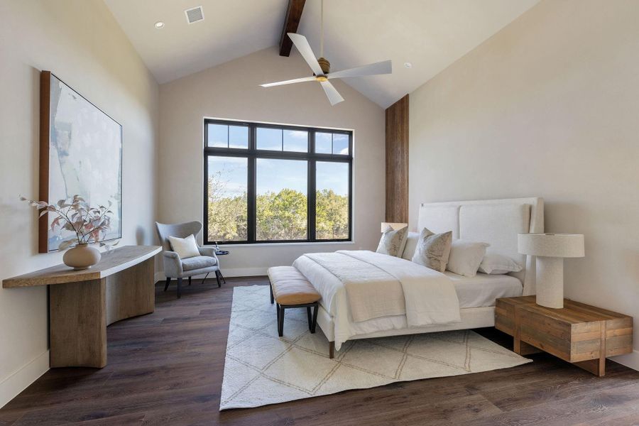 Main bedroom paradise with vaulted ceilings and giant windows overlooking the one acre lot.