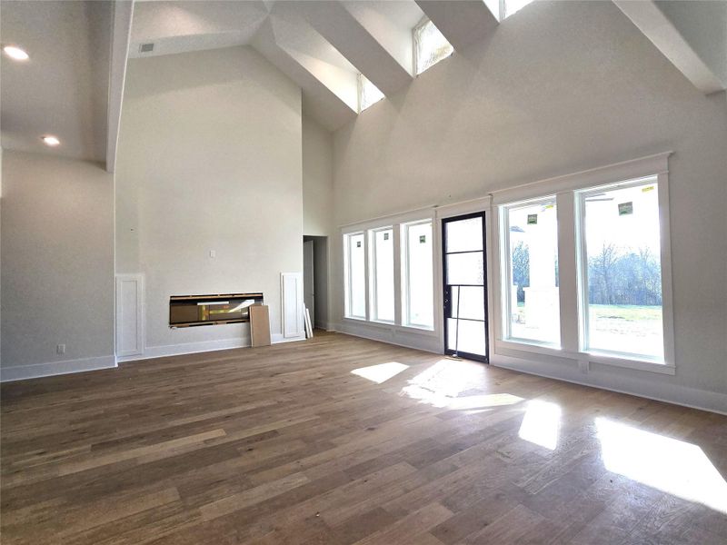 Living room with fireplace and door leading to covered patios