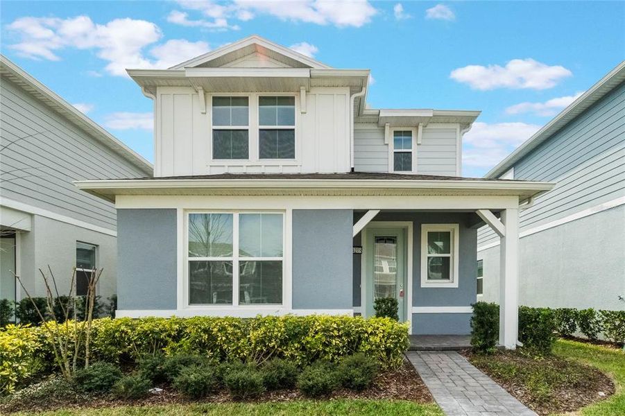 Front exterior of a new home in Isles of Lake Nona, Orlando, FL, highlighting curb appeal (Image 25).
