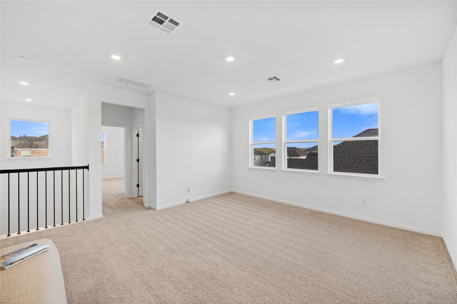 Unfurnished room featuring light carpet, recessed lighting, and plenty of natural light
