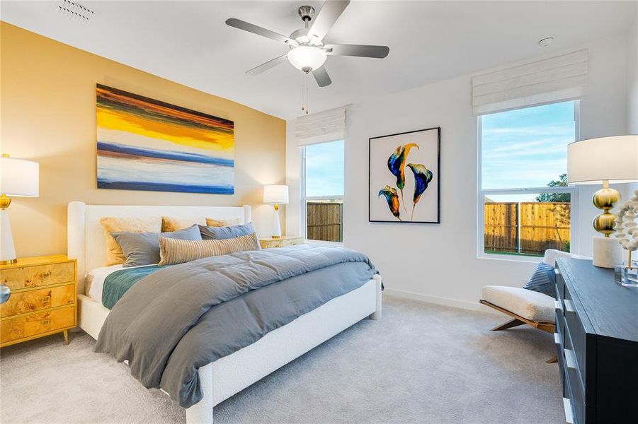 Bedroom featuring visible vents, ceiling fan, light carpet, and baseboards