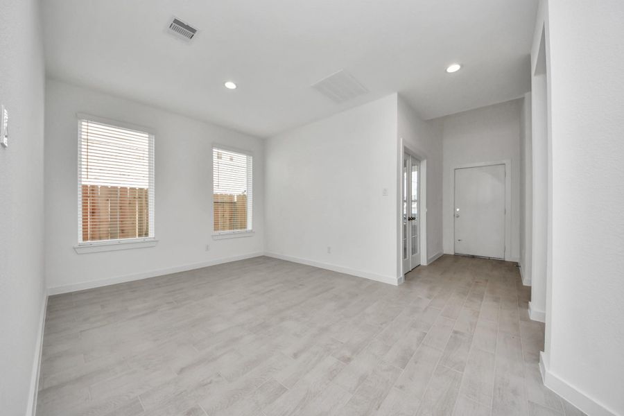 Make memories gathered around the table with your family and friends! This spacious dining room features elegant flooring, custom paint, and adjacent to family room and kitchen for open concept feel. Sample photo of completed home with similar floor plan. Actual colors and selections may vary.
