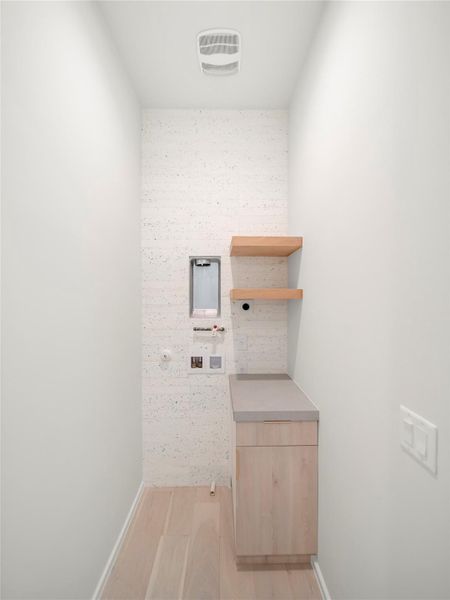 Laundry area featuring light wood-style flooring and hookup for a washing machine